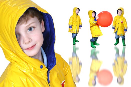 Four year old boy with big blue eyes in a yellow rain coat and green frog boots. Shot with the Canon 20D.