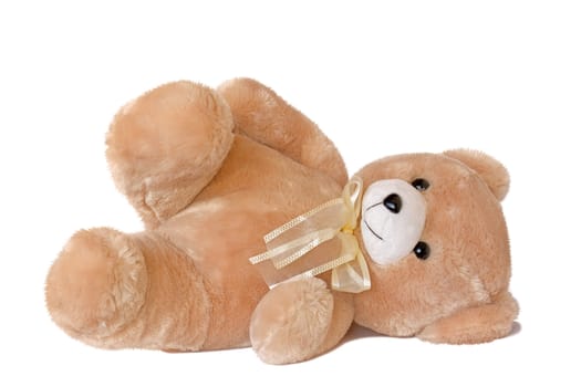 Teddy bear lying on its side, isolated on a white background.