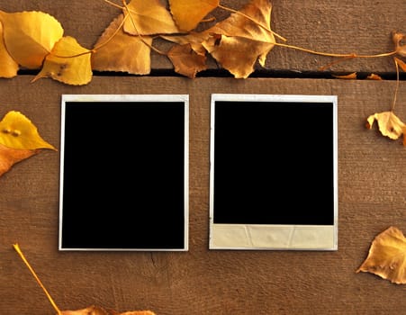 two empty photo frame over wooden background