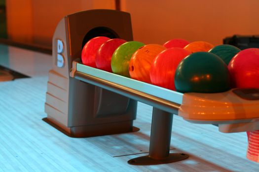 colored bowling bolls in a row 