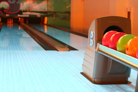 colored bowling bolls in a row 