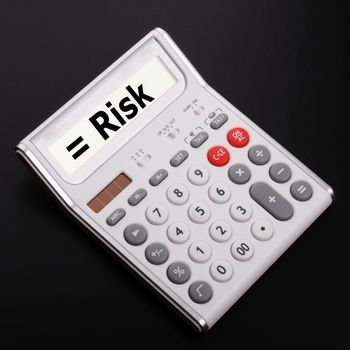 risk management concept with calculator showing financial success