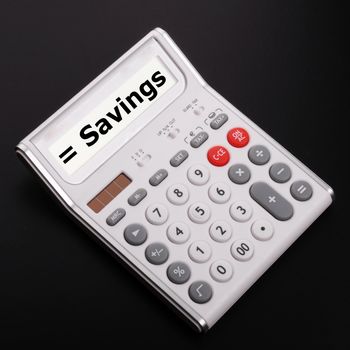 save money concpet with word savings on calculator