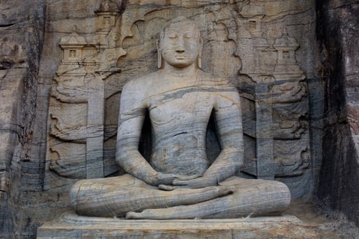 The Seated Buddha was carved out of a granite cliff at Gal Vihariya in Pollanaruwa, Sri Lanka. It is part of one of the most important Buddhist shrines in the world and also a part of a UNESCO World Heritage Site.