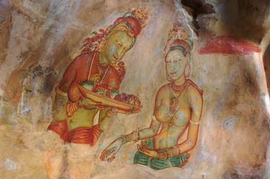 Women with offerings of flowers: one of the 5th century frescoes at the ancient rock fortress of Sigiriya, a UNESCO World Heritage Site in Sri Lanka.