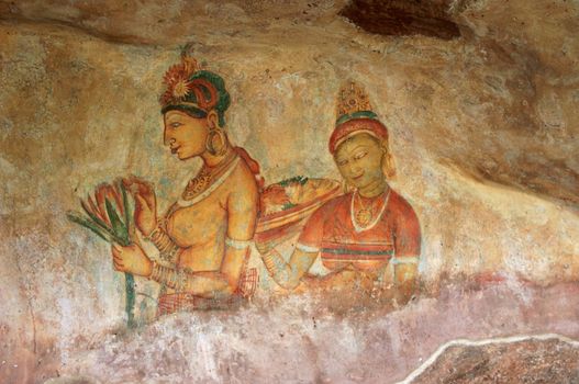 Two Sigiriya maiden with flowers: one of the 5th century frescoes at the ancient rock fortress of Sigiriya, a UNESCO World Heritage Site in Sri Lanka.