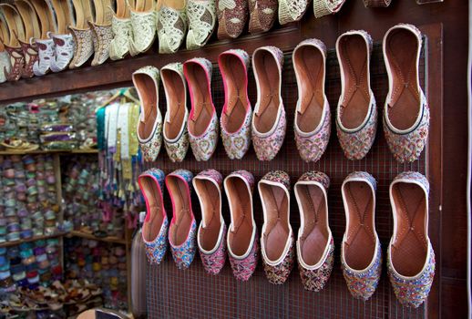 Arabian shoes on sale in a traditional souk in old Dubai, UAE.