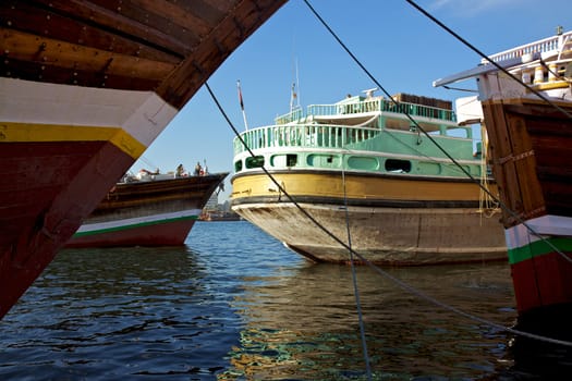 Traditional wooden trading dhows moored in Dubai Creek, UAE.