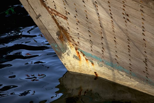 The bow of a traditional wooden trading dhow moored in Dubai Creek, UAE.