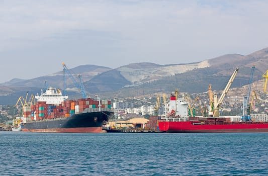 Cargo ships are loaded at port of Novorossiysk, Russia.
