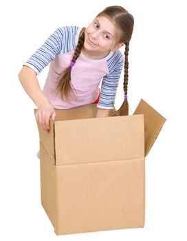 The girl rummages in a cardboard box