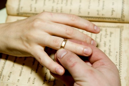 The man's hand dresses a ring on a female finger taken as close up 