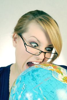 The angry womanl bites the globe on the white