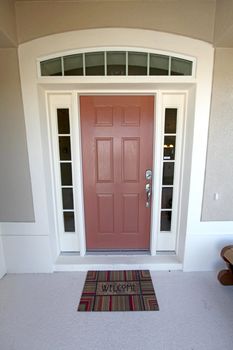 A Front Door with Mat welcoming you into the Home.