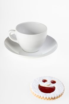 smiling cookie and a coffee cup isolated on white background