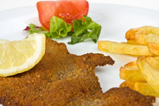 detail of a viennese schnitzel on a plate