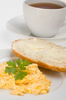 scrambled eggs and bun on a plate