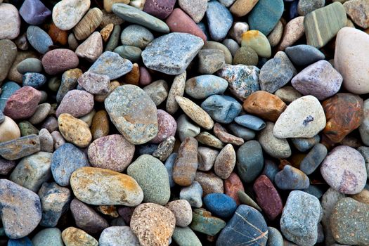 Pebbles and stones lying on a beach. A great background.