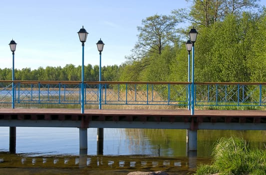 Wooden pier with lanterns on  lake Valdai, Russia.