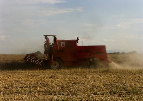 Big red combine performing his job