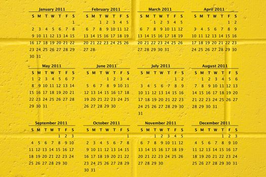 2011 calendar on fun school yellow cement block wall background, great texture.