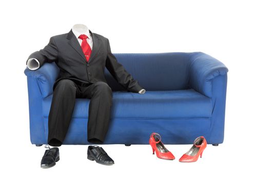 	Classic empty male suit is sitting on blue textile coach near red female shoes. Conceptual photo. Isolated over white
