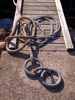 Classical anchoring point made of cast iron in a port marina / nautical background veritcal image