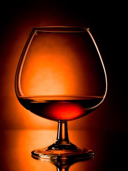 glass of cognac, dramatic light, vibrant colors