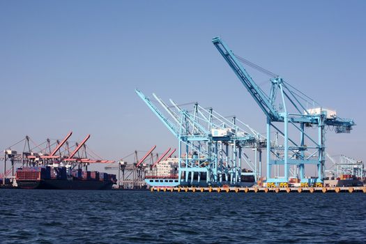 Two large cargo container ships waiting for the cranes to unload them