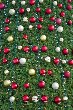Christmas pine, decorated with colorful balloons. Fragment, close-up.