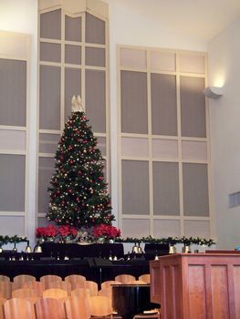 Christmas tree with angel on top in a religious church