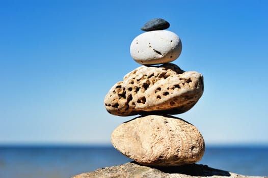 Few different pebbles at the edge of sea cliff