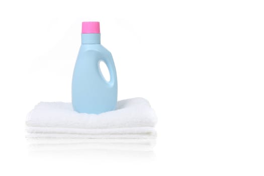 Fabric Softener Detergent Container Sitting on a White Folded Towel With Copy Space