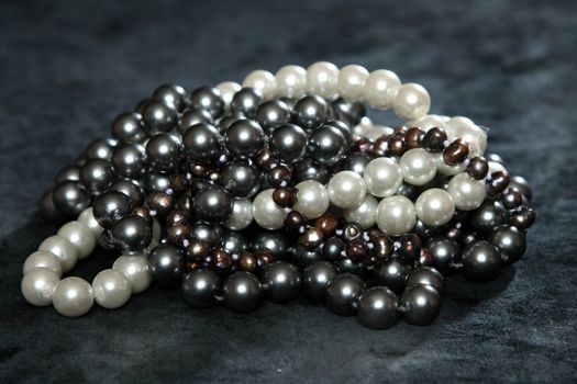 Three NECKLACES FROM pearls on a black velvet