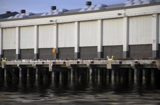 Commercial storage building on pier with reflective water