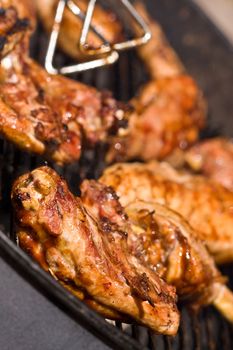 barbecue chicken on the grill with sauce