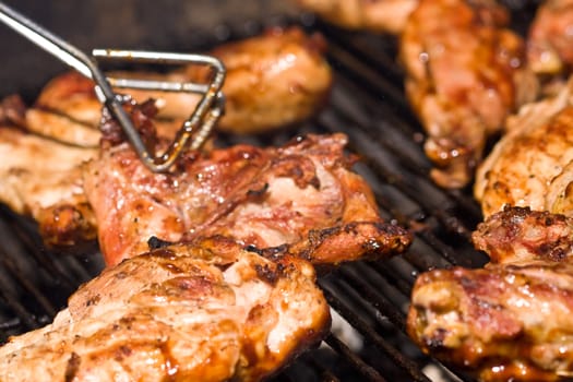 barbecue chicken on the grill with sauce