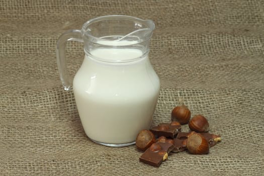 Milk jug on brown background