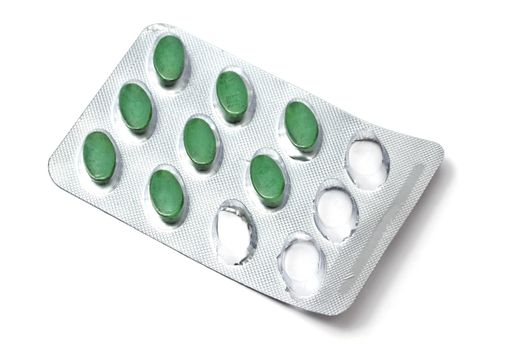 green pills isolated on white background 
