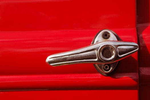 door lever from a red vintage automobile
