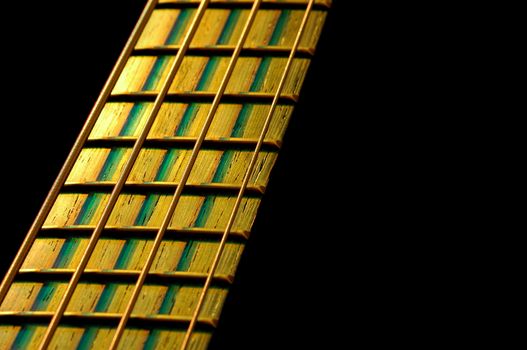 bass guitar fretboard under stage lighting