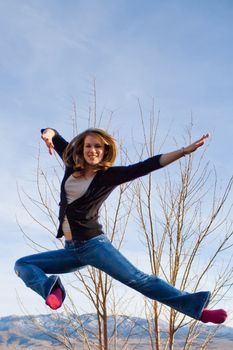 A girl doing a karate pose in mid air!