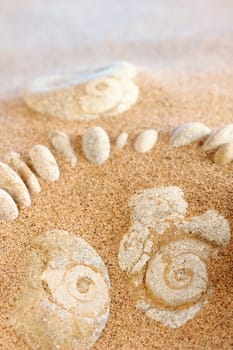 Different white cobblestones put into the sand