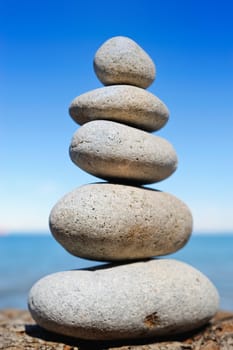 Different white cobblestones put as a stack on the cliff