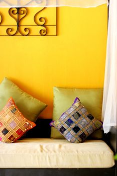 Bright sofa covered with ethnic pillows - home interiors.