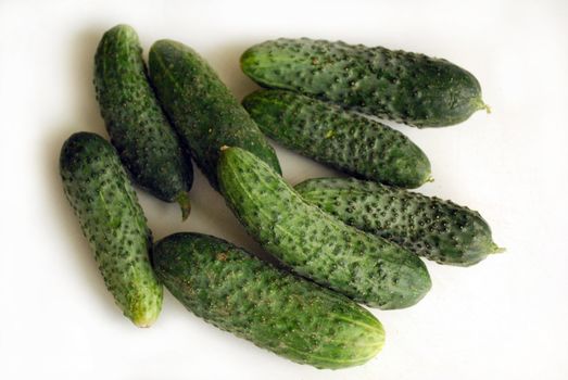 a hand of Cucumbers isolated on a white background
