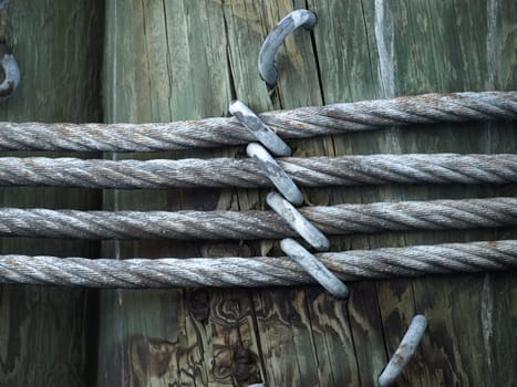 A large pier post shown up close with steel cables