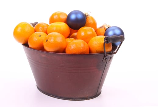 Mandarins and christmas balls over white