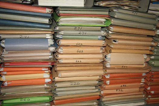 Multicolored cardboard files containing loads of paperwork