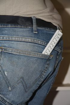 A folding rule sticking out of a pair of jeans